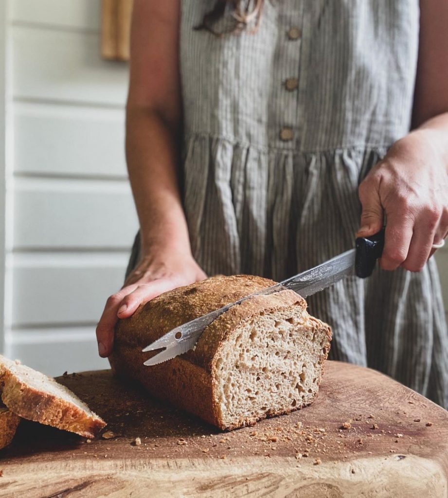 woman cutting bread loaf