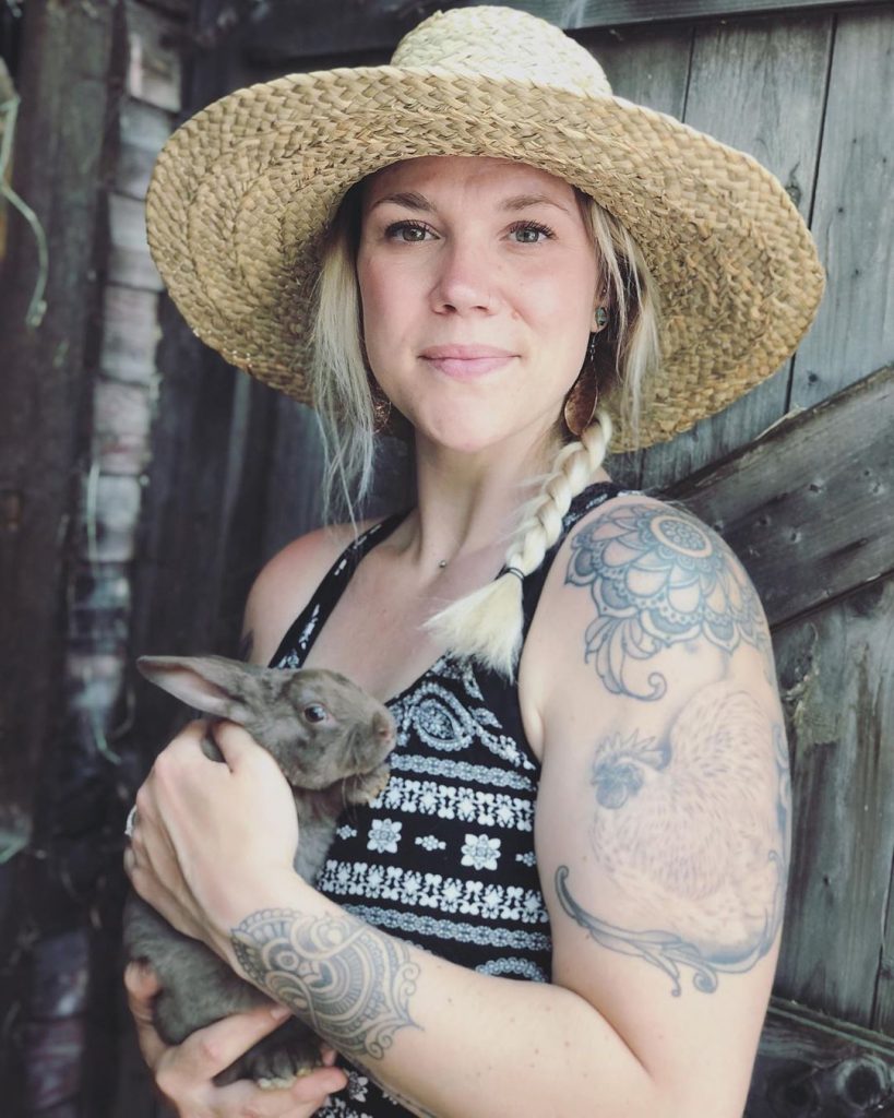 woman holding small rabbit